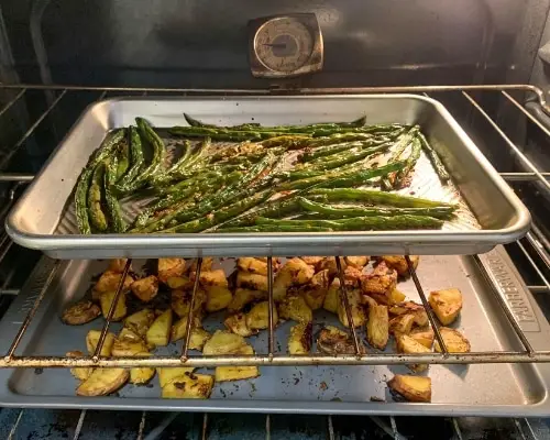 oven roasted potatoes and green beans in oven