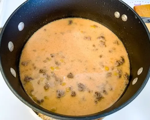 cheeseburger helper ingredients in a pot