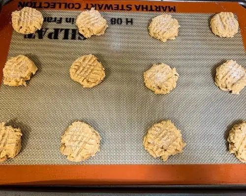 unbaked peanut butter cookies on baking sheet