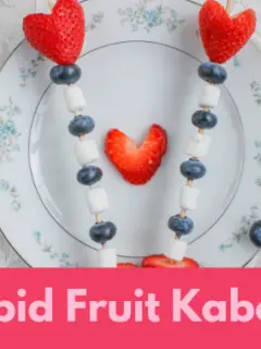 2 cupid fruit kabobs on a plate